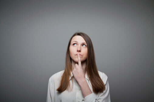 woman with finger on mouth has side effects of adderall